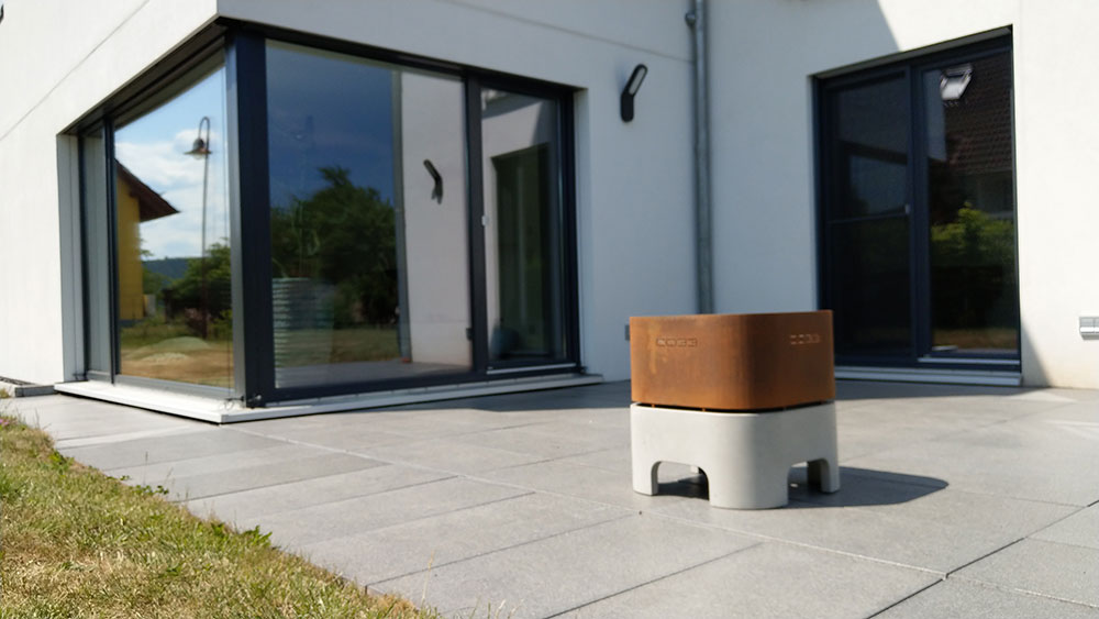 Firebowl made of gray concrete and Corten steel