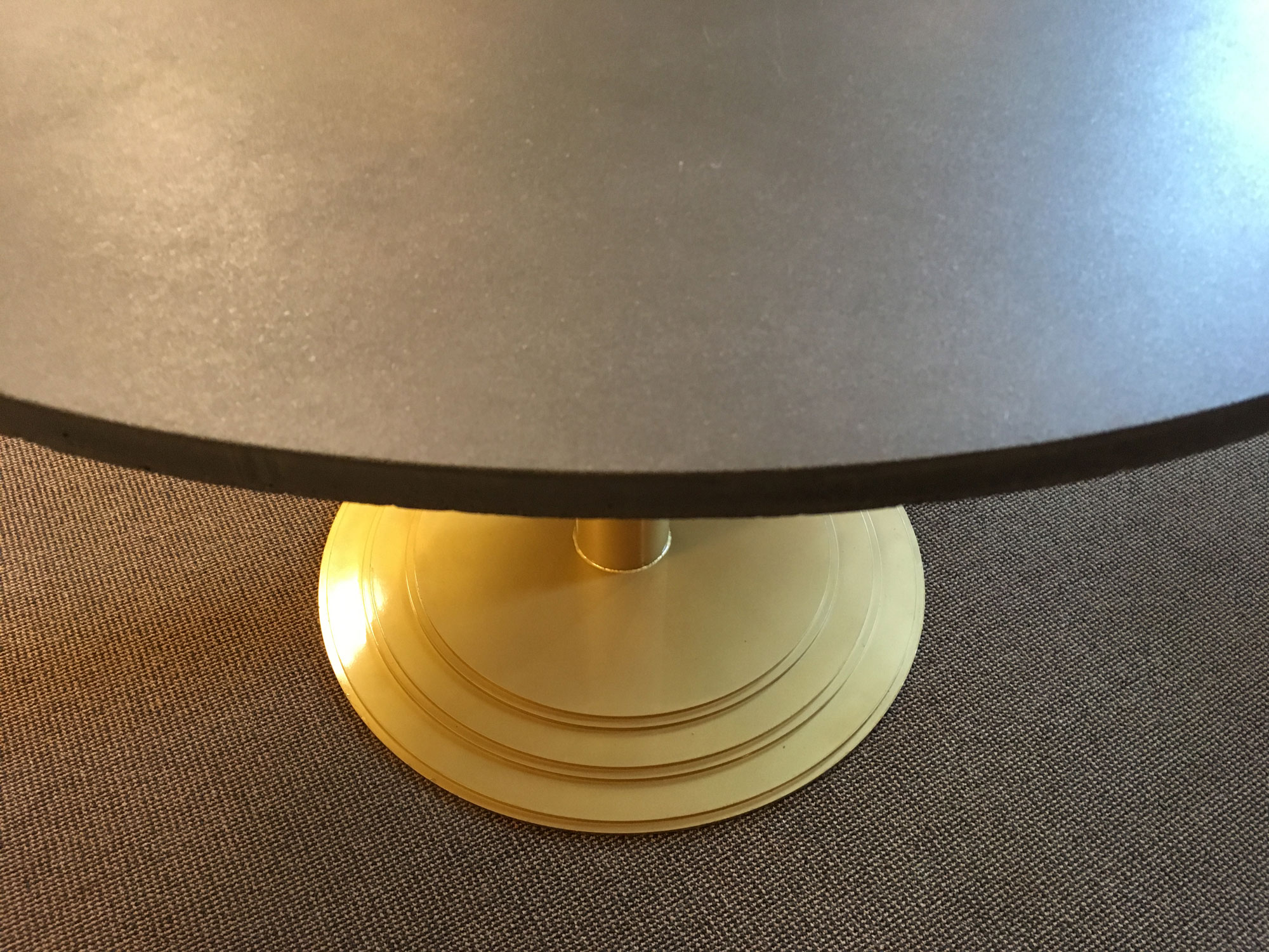 Detail of TABULA COSMOS bespoke office table in black concrete with gold lacquered feet