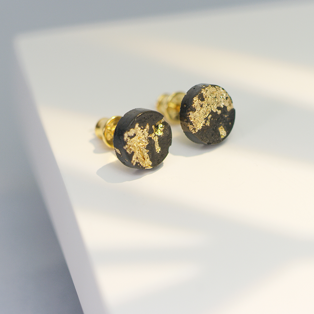 Concrete Jungle concrete jewelry elegant black concrete stud earrings with gold leaf, close-up